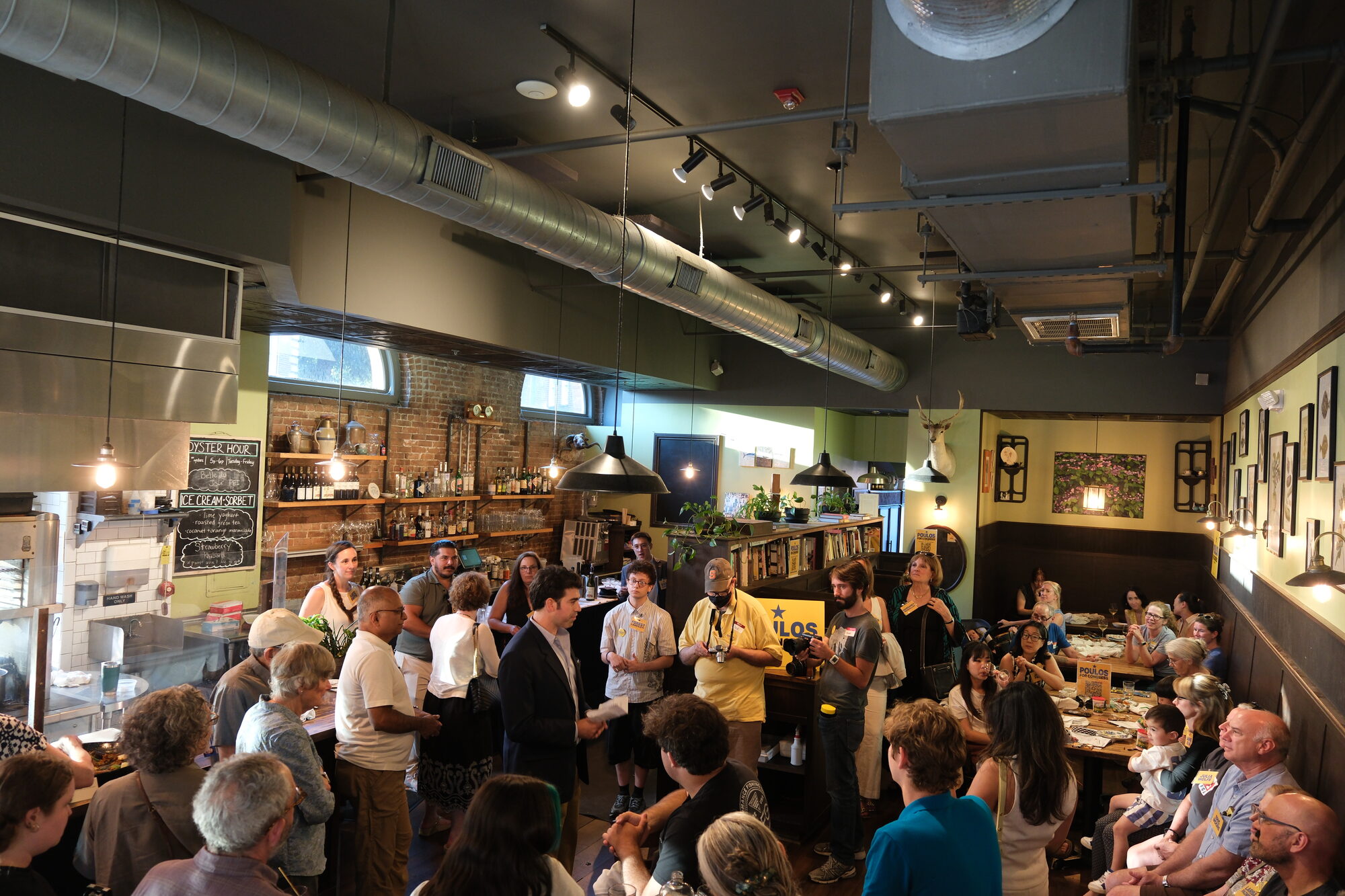 Supporters filling Thistle & Leek in Newton for a Jason Poulos campaign fundraiser, June 29, 2026