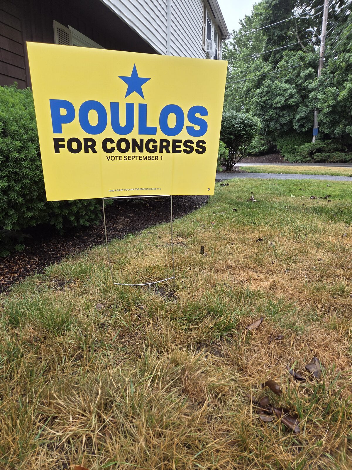 A Poulos for Congress lawn sign on display in a yard in MA-04